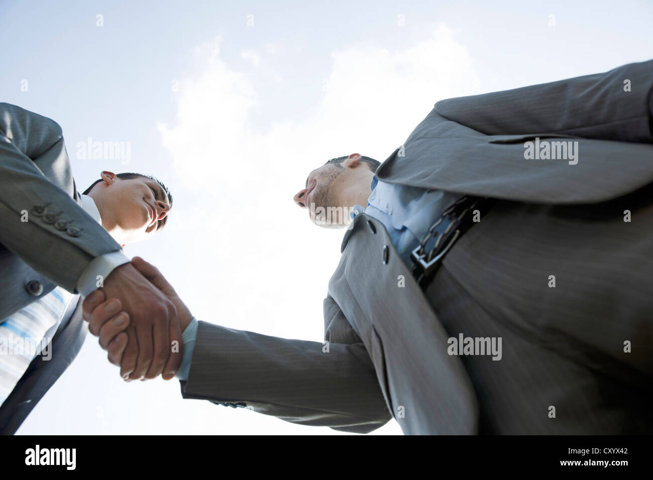 Two businessmen greeting each other with a handshake Stock Photo - Alamy