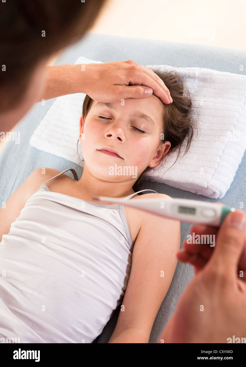 Pediatrician reading a digital fever thermometer showing the high