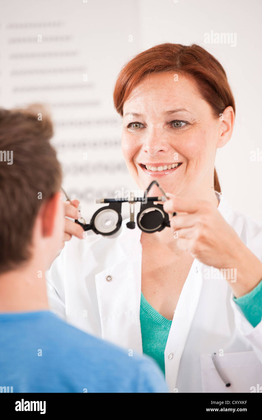 Ophthalmologist putting a pair of glasses for a vision test on a