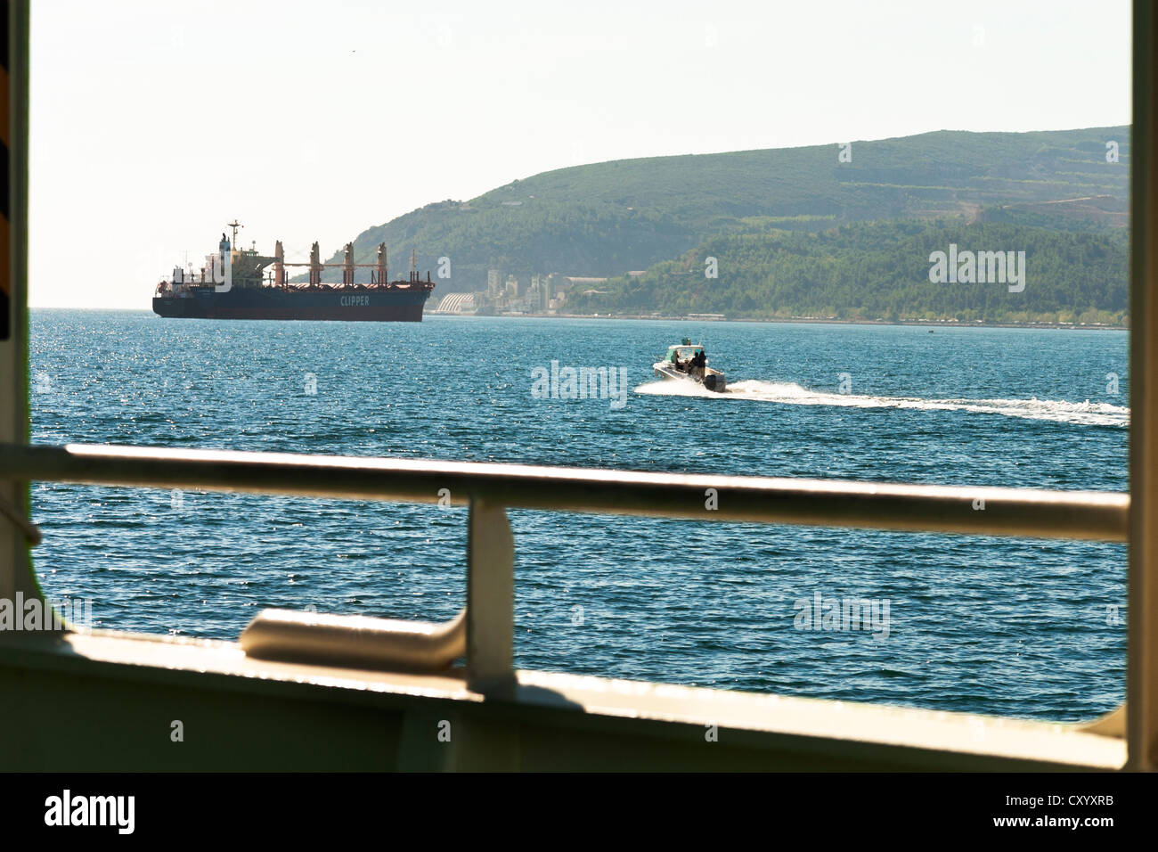 Ship and small boat navigating in the Sado River estuary, Setubal, Portugal Stock Photo