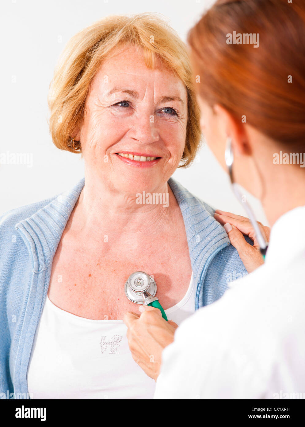 Patient being monitored by her family doctor with a stethoscope Stock Photo Alamy