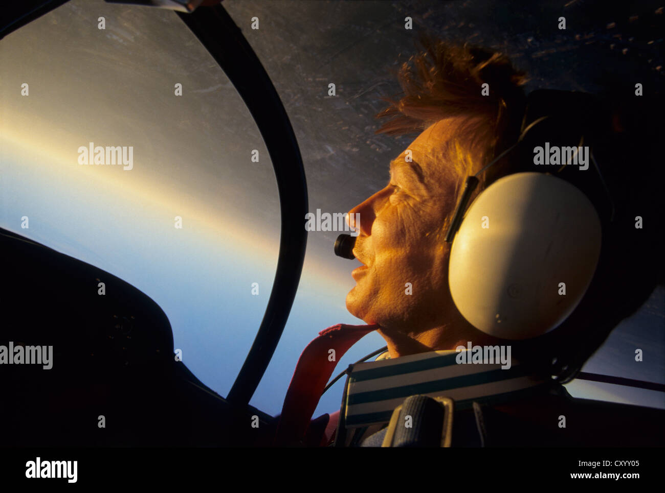 Inside view of a pilot portrait during a looping flight on sunset with a french Mudry Cap 10b plane, France Stock Photo
