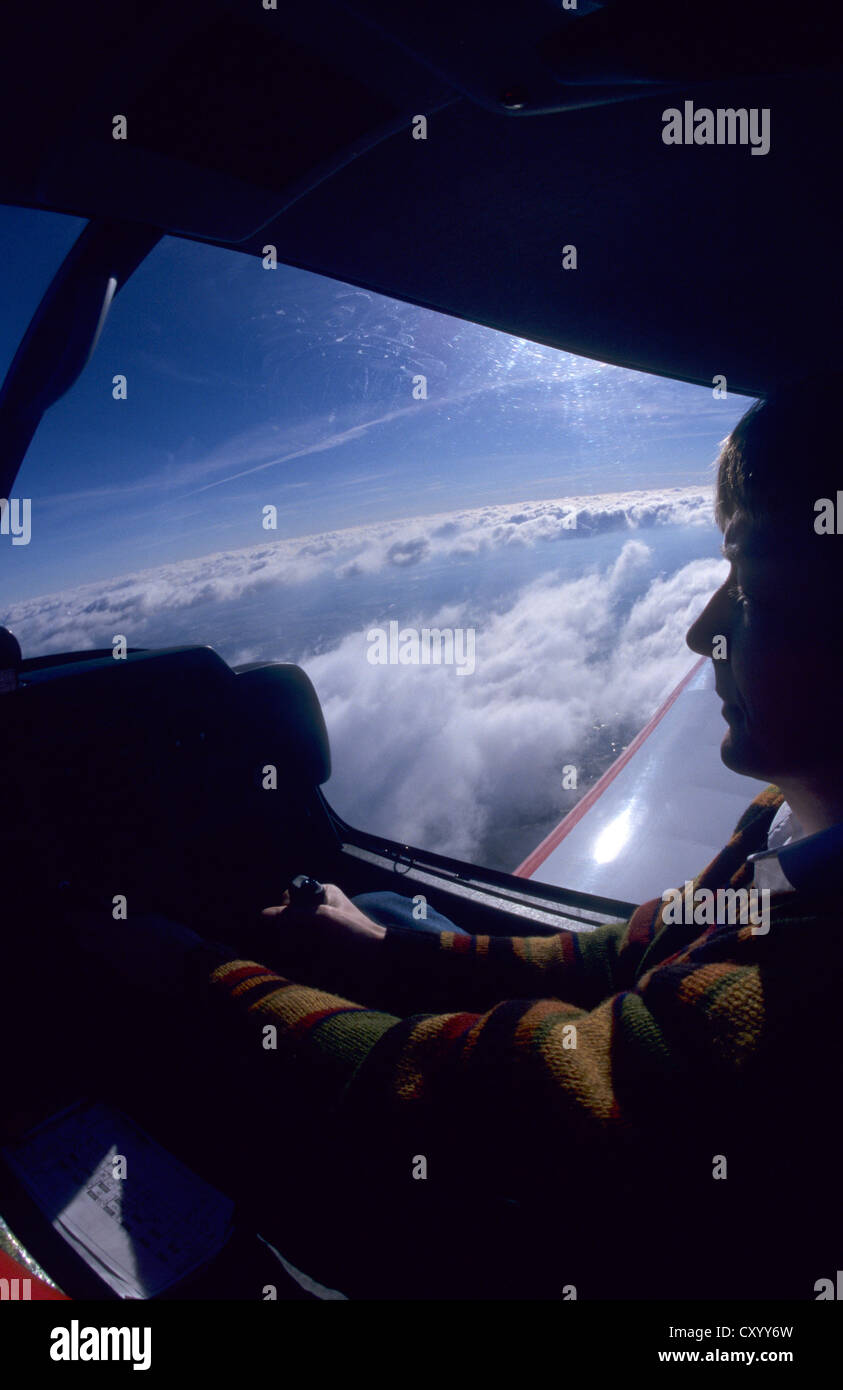 Pilot flying over Cumulus clouds on VFR on top flight with a Robin DR