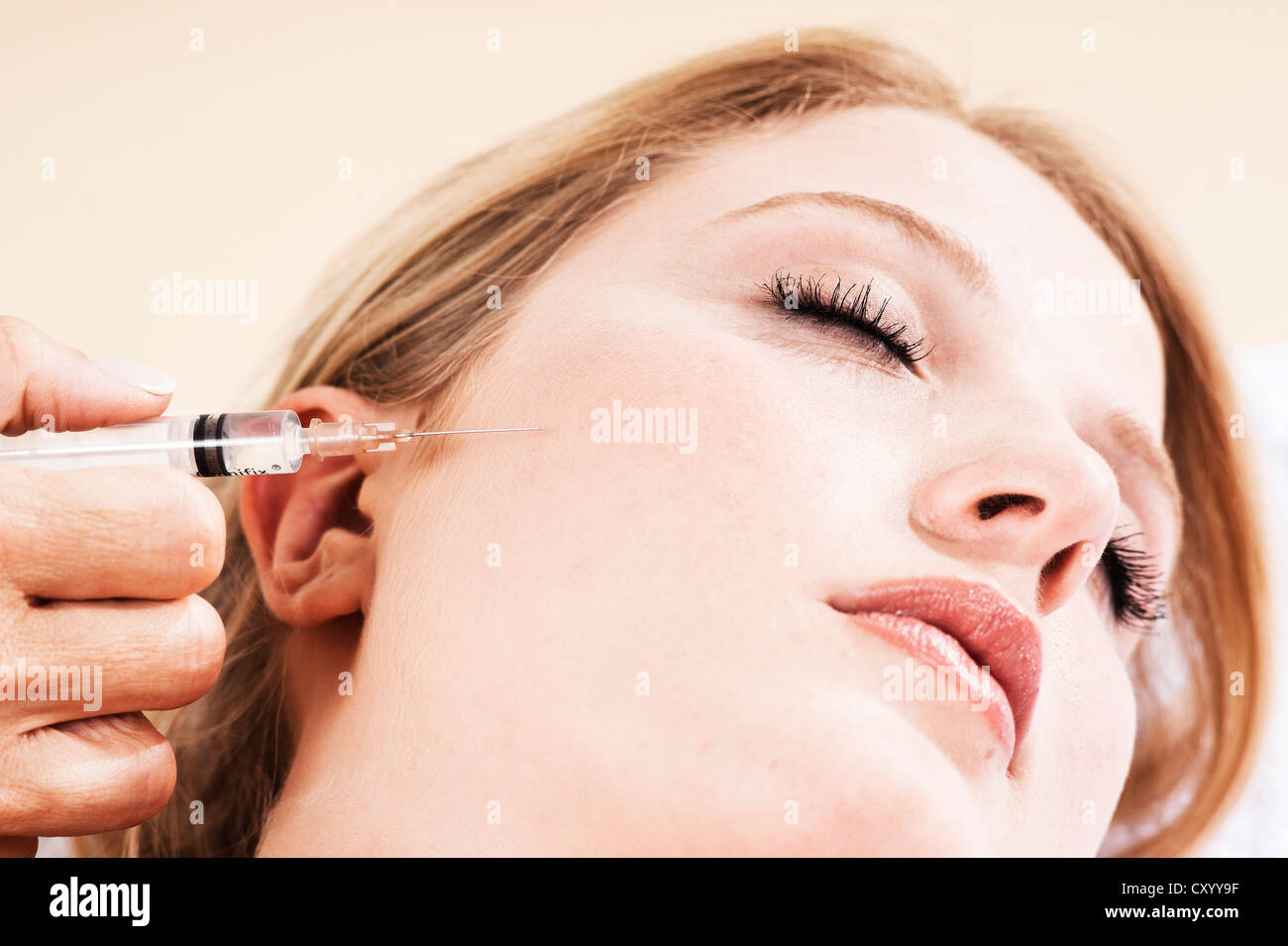 Syringe on the face of a patient, Botox treatment Stock Photo Alamy