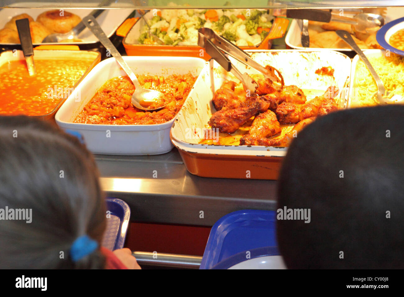 London Primary School, UK. Children queuing for hot lunch at refectory canteen. NB Cannot be recognized Stock Photo