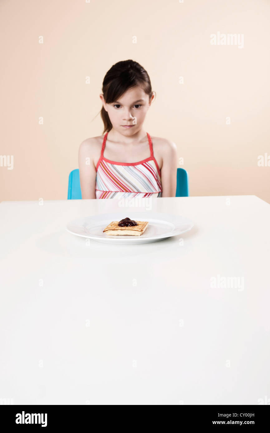 Girl looking hungrily towards a waffle Stock Photo - Alamy