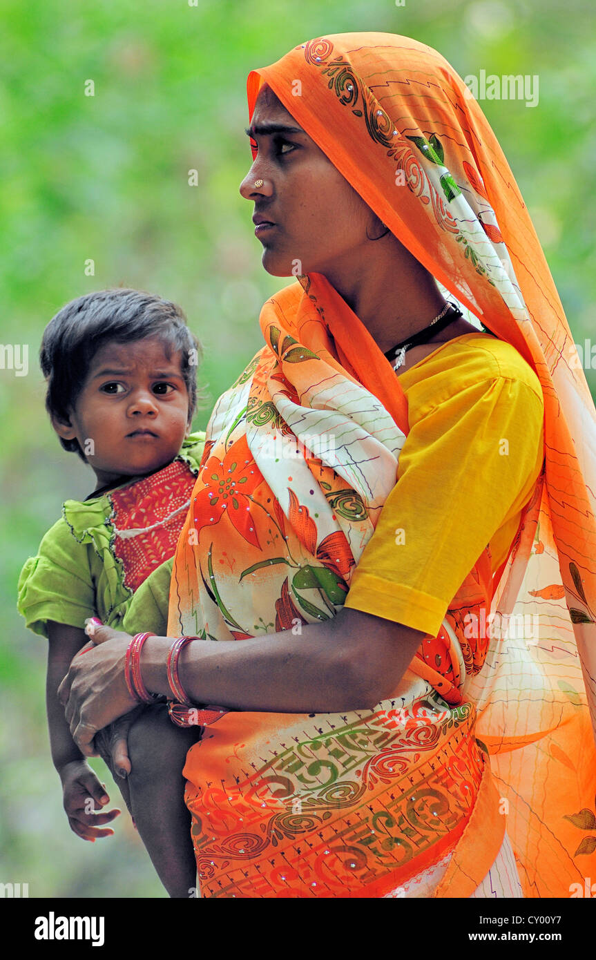 Indian woman carrying a small child in her arms, Bharatpur, Rajasthan, India, Asia, PublicGround Stock Photo