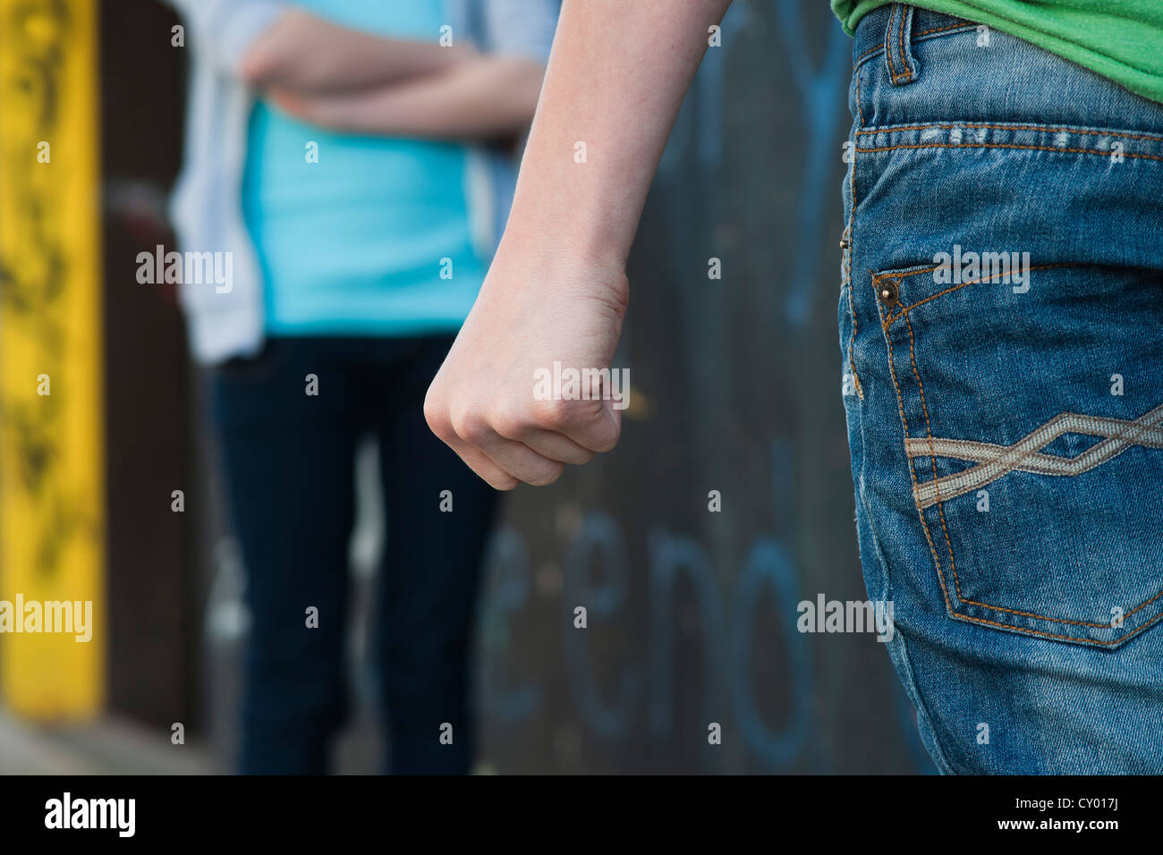 Boy threatening a girl with his fist Stock Photo
