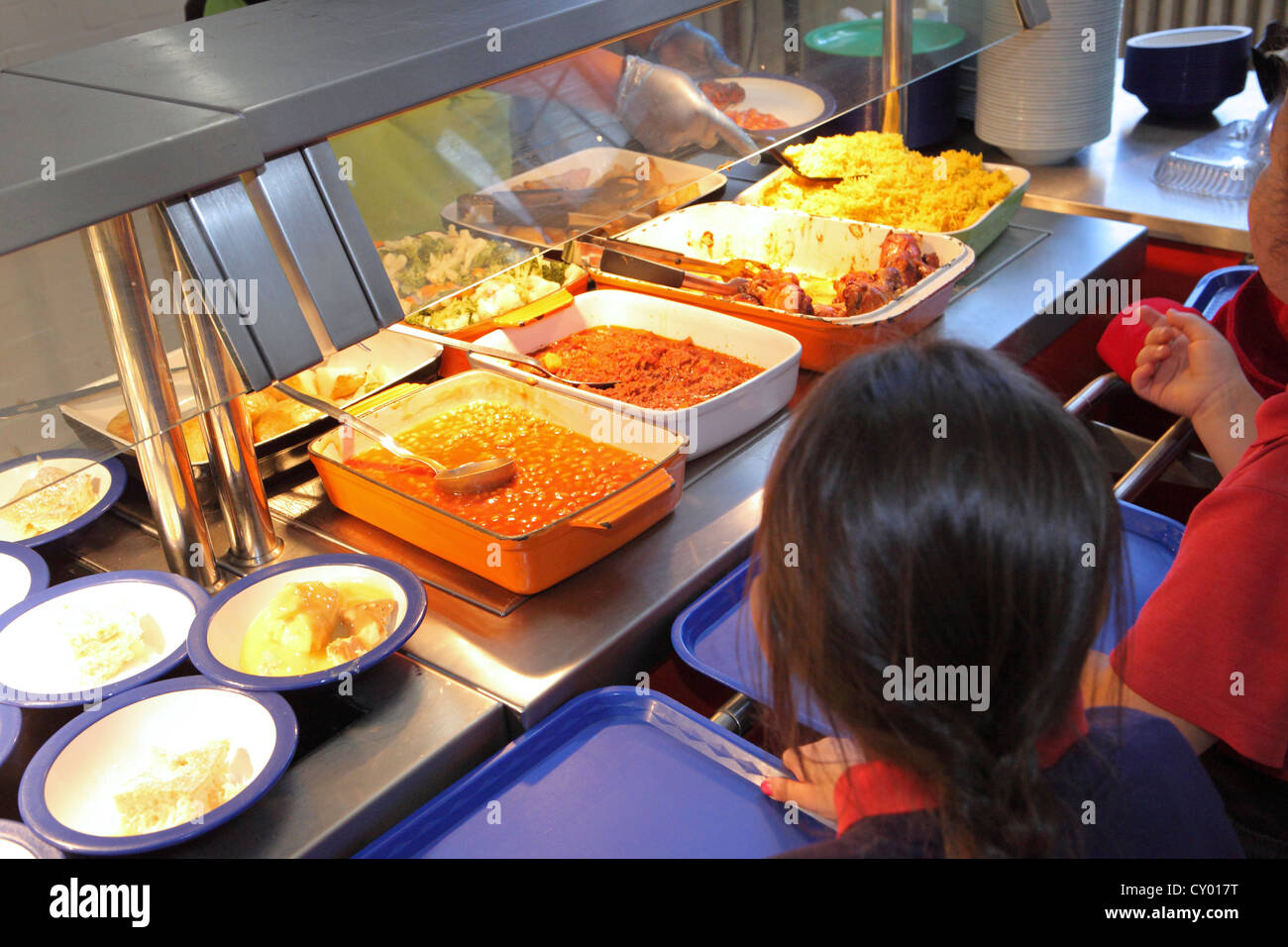 London Primary School, UK. Children queuing for hot lunch at refectory canteen. NB Cannot be recognized Stock Photo