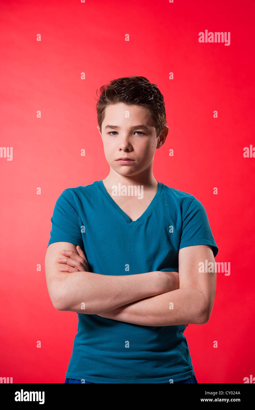 Boy with a serious expression and folded arms Stock Photo Alamy