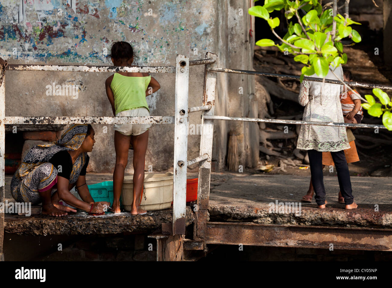 Mother and Girl doing Laundry on the River Banks in Kolkata, India Stock Photo