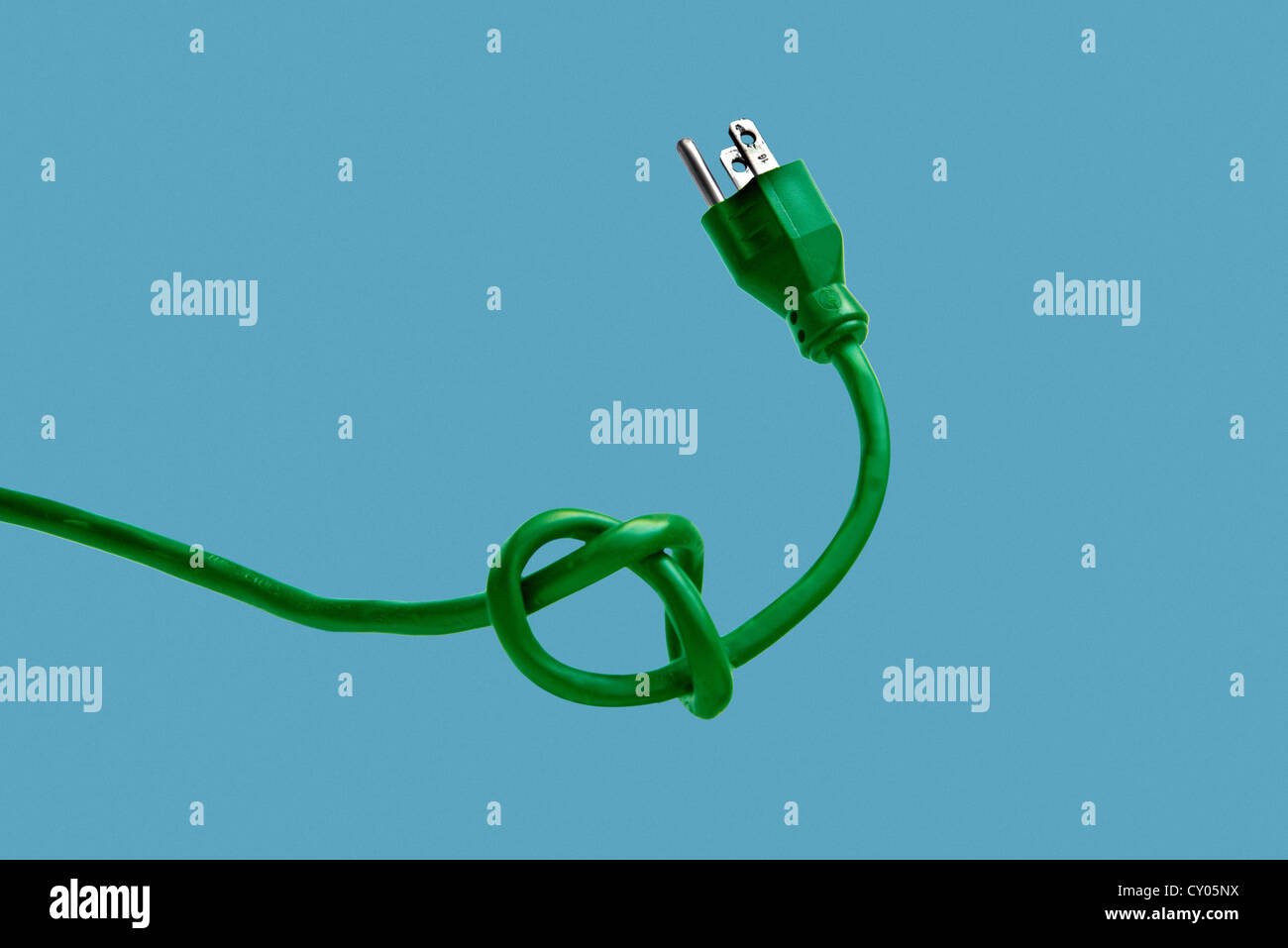 green 3 prong plug tied in knot Stock Photo