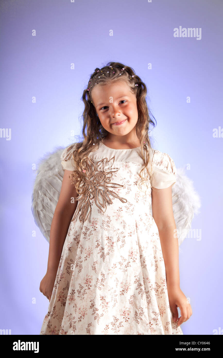 Cute little girl with pigtail hairstyle and angel wings Stock Photo