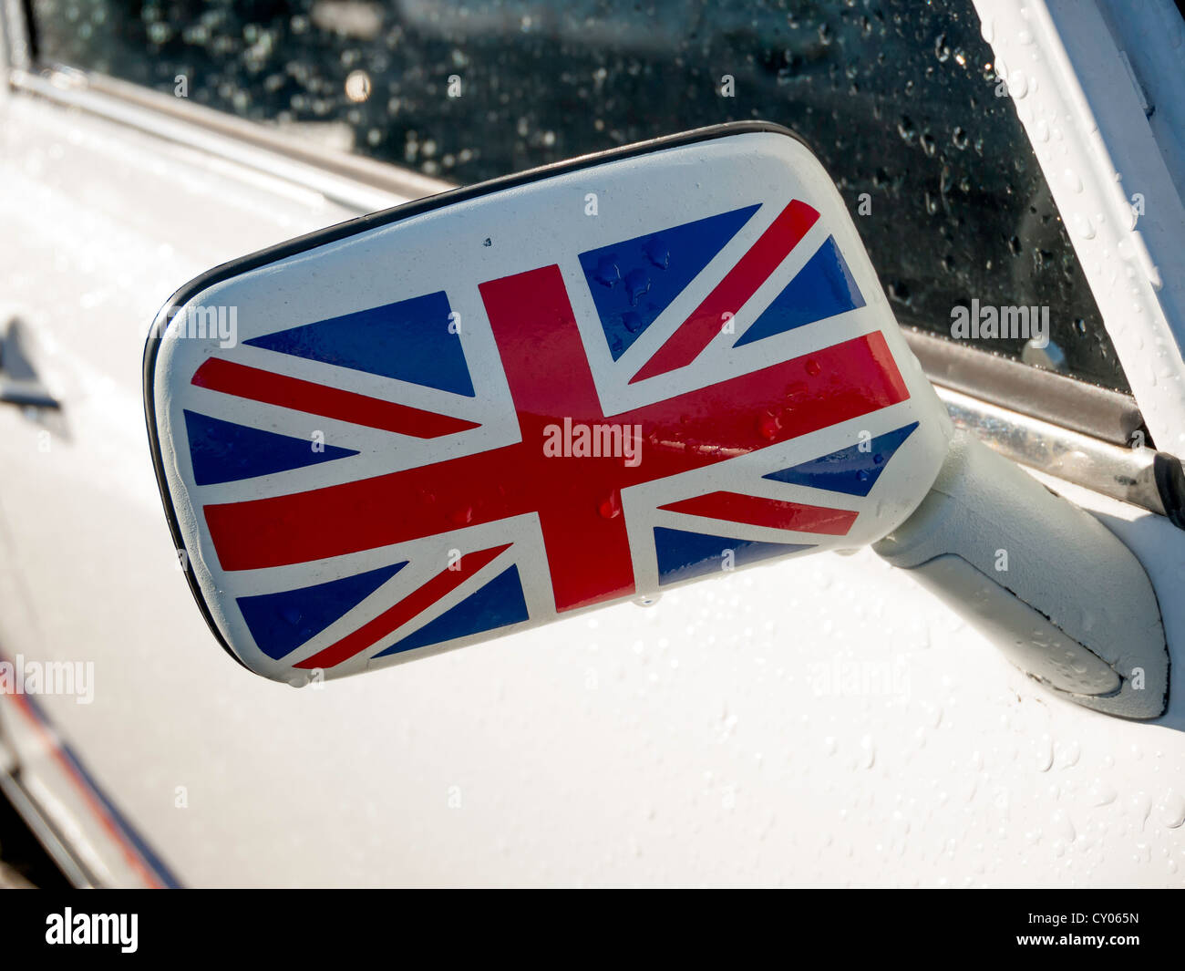 Close up of a wing mirror painted with a Union Flag on an historic 1993 white BMC  Mini 1275 motor car Stock Photo