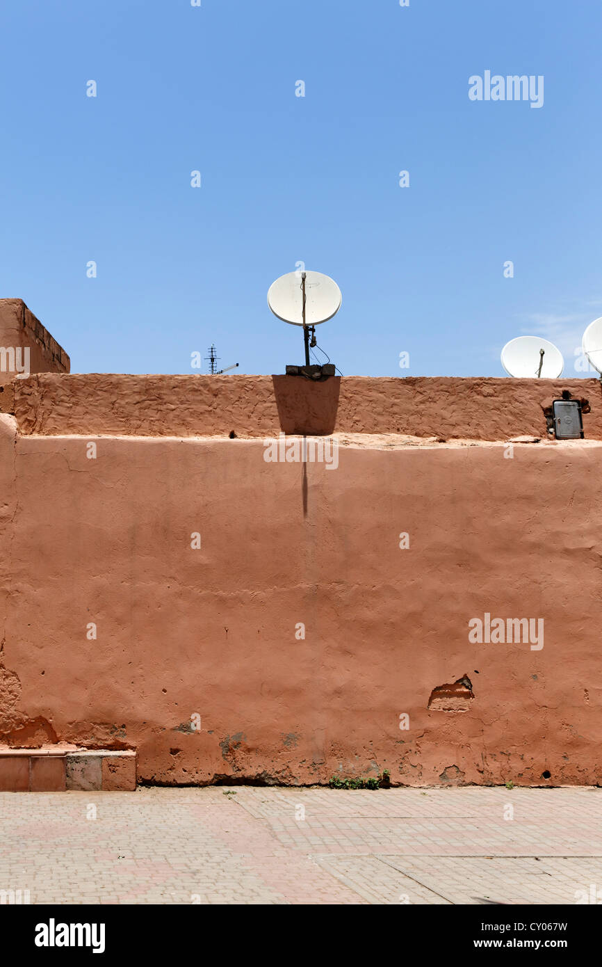 Satellite dish on a mud wall in Marrakech, Marrakech-Tensift-El Haouz, Morocco, North Africa, Africa Stock Photo