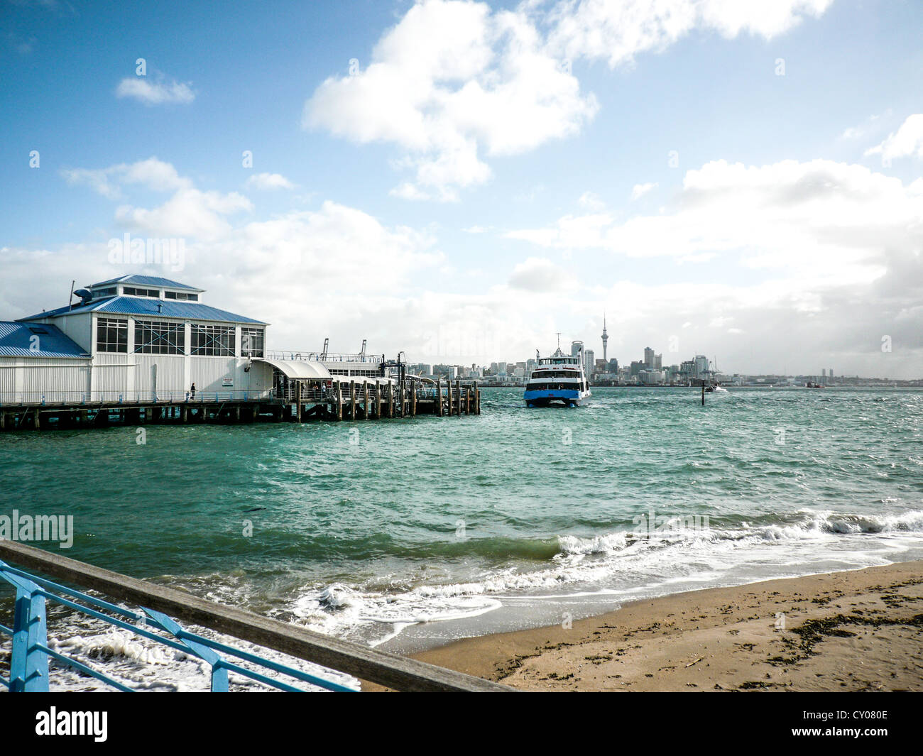 Devonport Ferry landing dock with Auckland, New Zealand skyline in the distance. Stock Photo