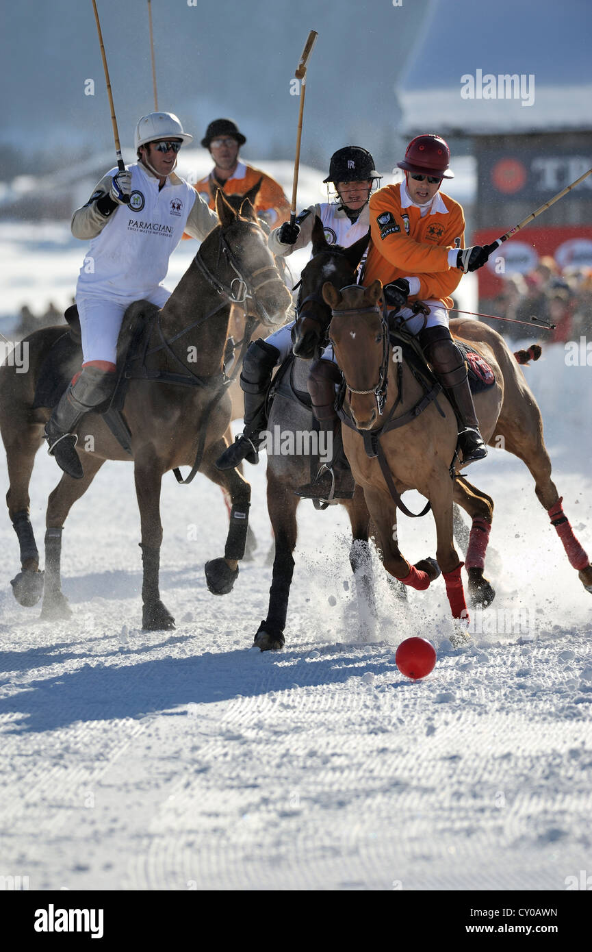 Polo players in a tough battle for the ball, left to right - Ignacio Garrahan and Marie-Jeanette Ferch of team 'Parmigiani' and Stock Photo