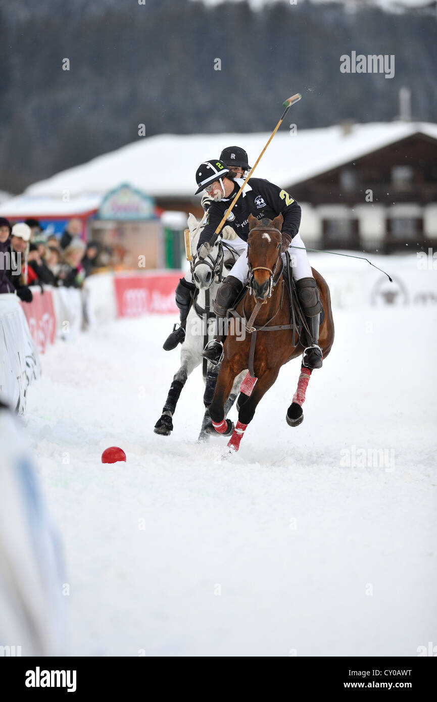 Matthias Maiquez of team 'Valartis Bank' followed by Marie-Jeanette Ferch of team 'Parmigiani', polo played on snow, polo Stock Photo
