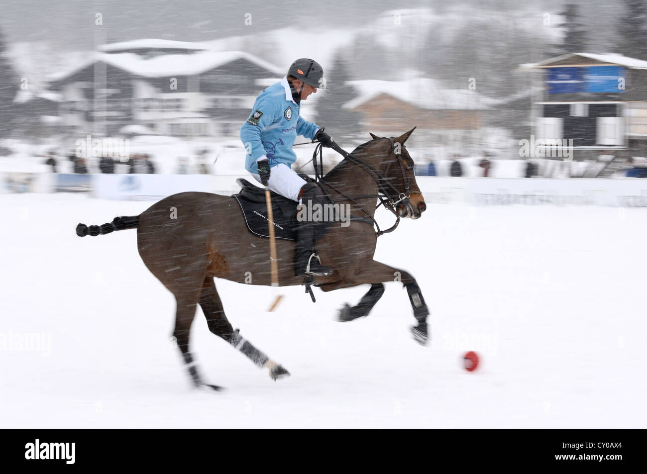 Uwe Schroeder of team 'Tom Tailor' riding through the snow, polo played on snow, polo tournament, Valartis Snow Polo World Cup Stock Photo