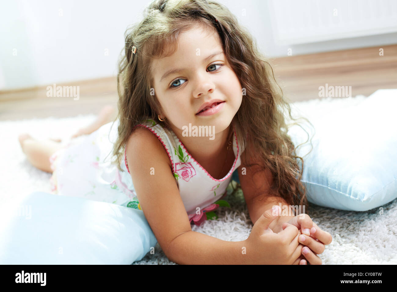 Portrait of lovely girl lying on the floor at home Stock Photo - Alamy