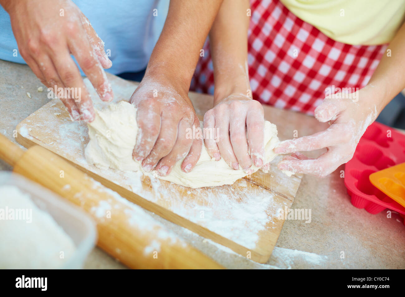 Female and male hands kneading dough in the kitchen Stock Photo - Alamy