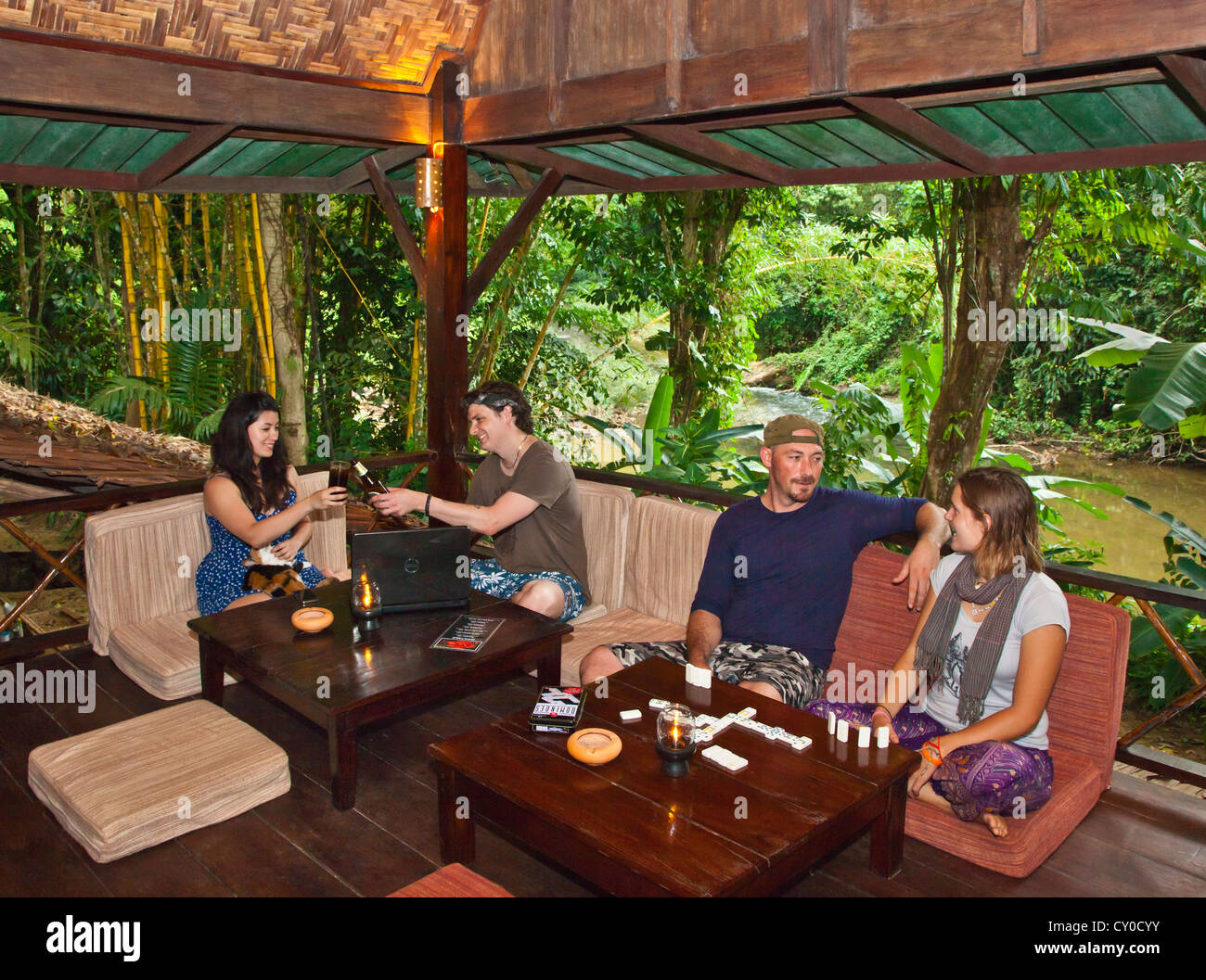 Guests enjoy the upstairs bar and restaurant at OUR JUNGLE HOUSE near KHAO SOK NATIONAL PARK - SURATHANI PROVENCE, THAILAND Stock Photo