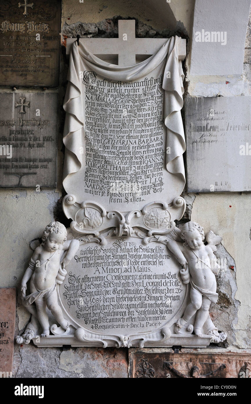 Old grave slab with putti sculptures at St. Peter's Cemetery, the ...