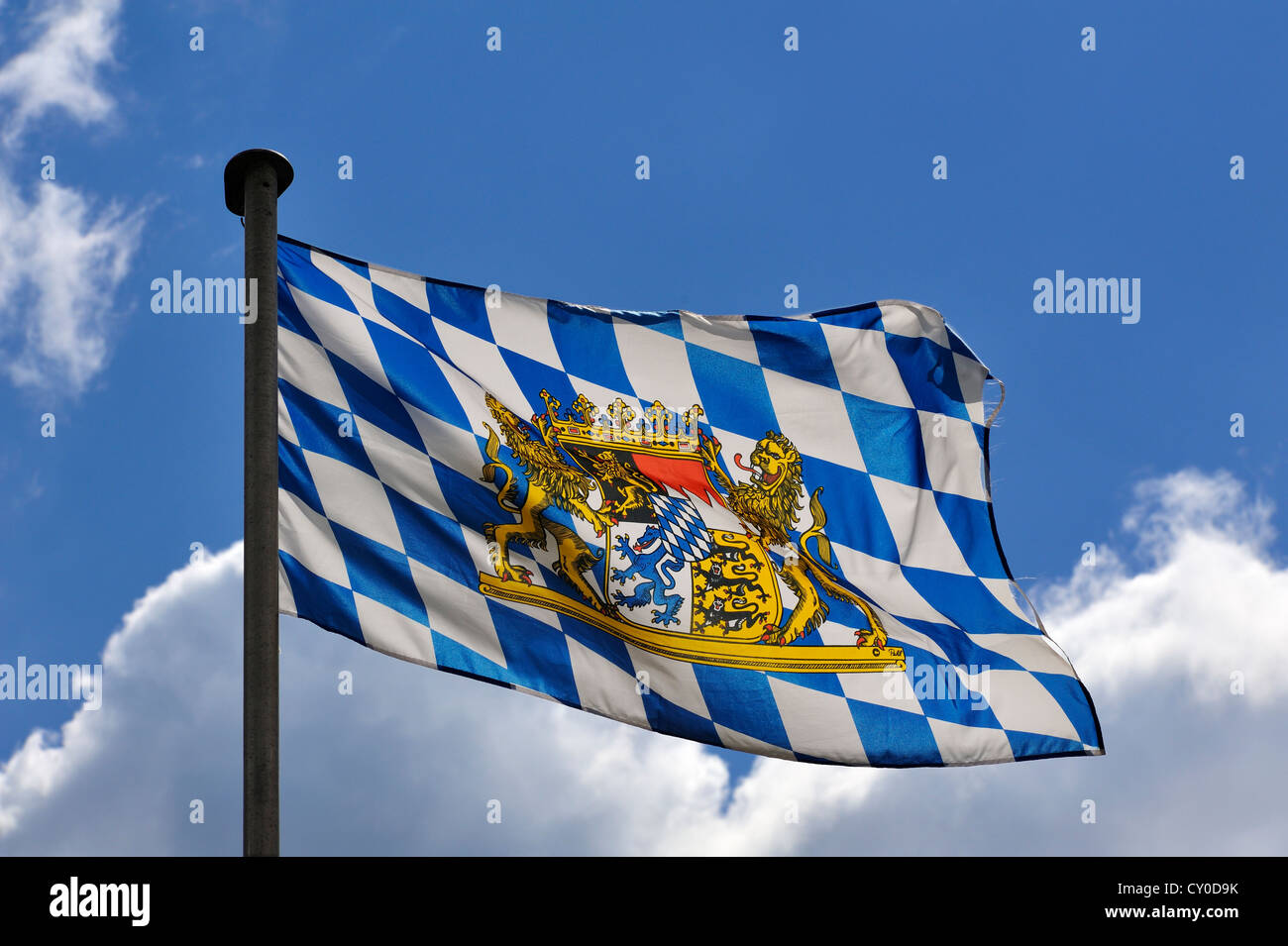 Bavarian flag flying in front of a blue sky with clouds, Hintersee, Upper Bavaria, Bavaria Stock Photo