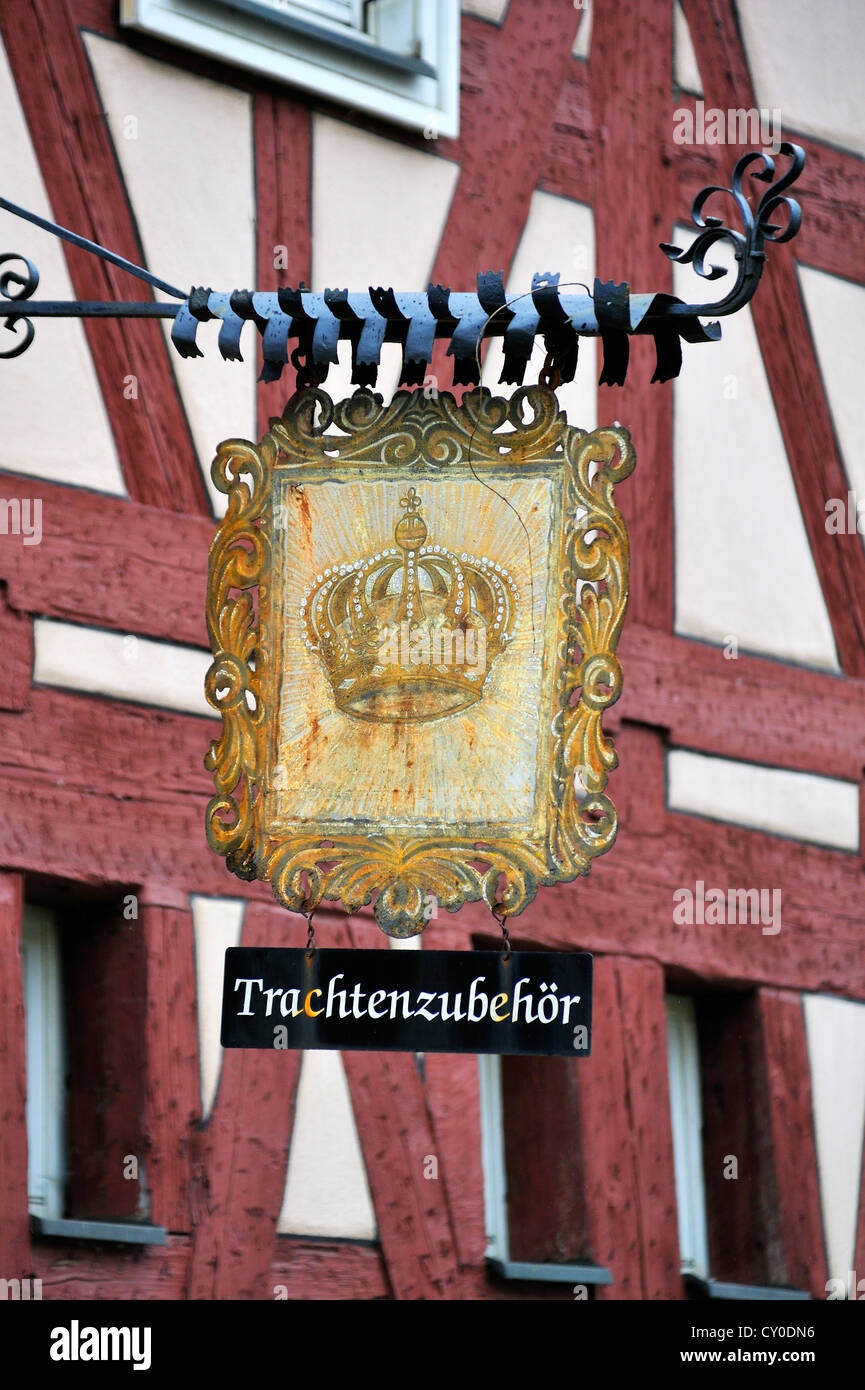Former Zur Golden Krone inn sign, today a shop selling traditional costumes, Kuhnreuth, Upper Franconia, Bavaria Stock Photo