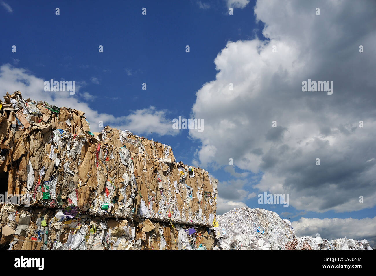 Pressed and stacked waste paper behind the wall of a recycling company ...