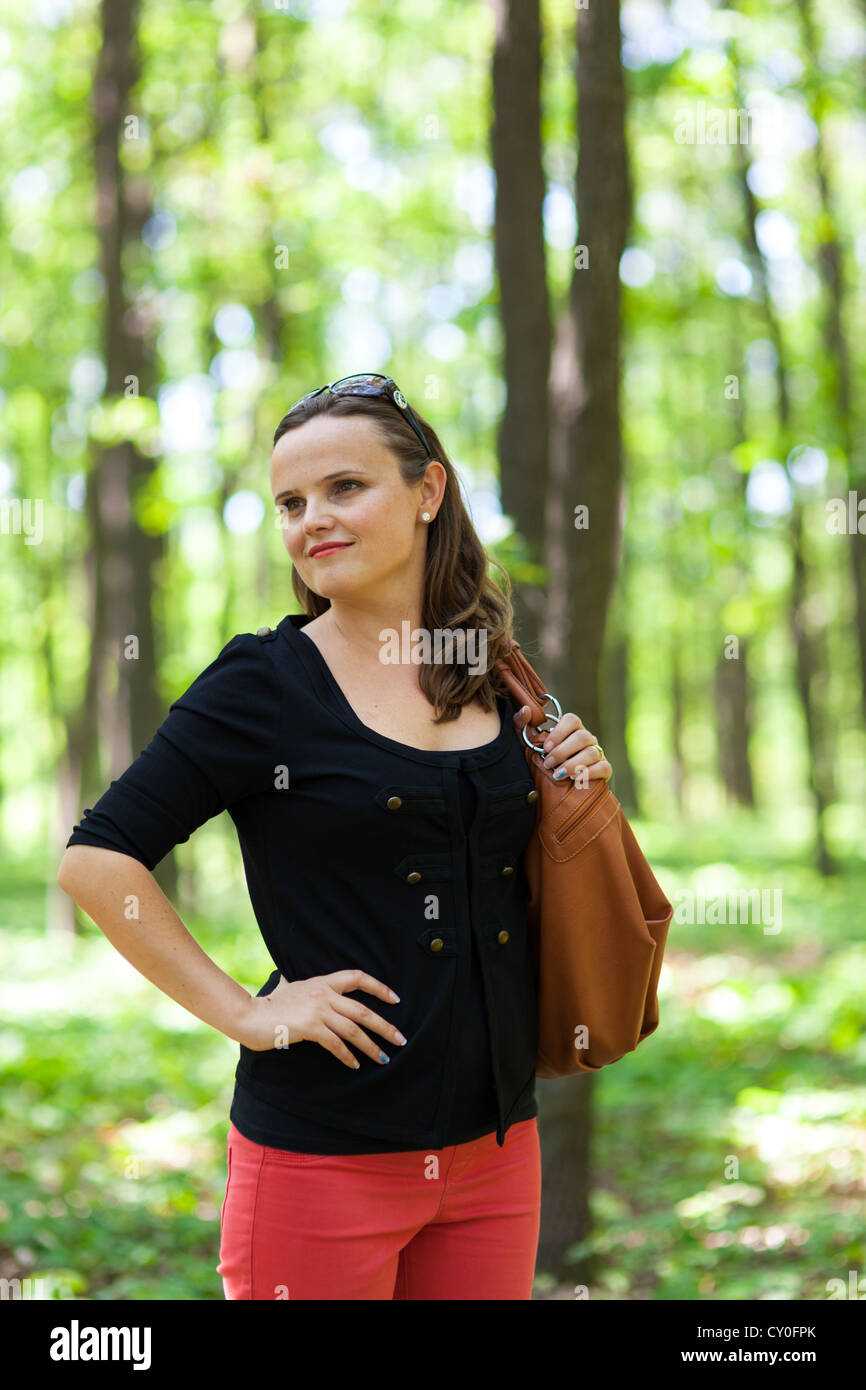 Closeup portrait of a beautiful young woman posing in the woods with ...