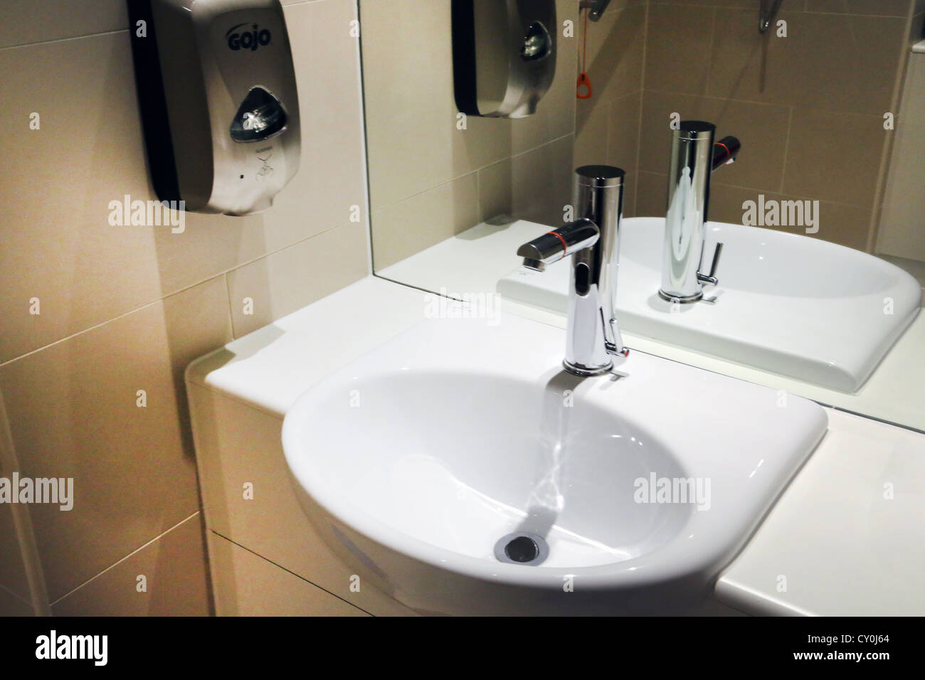 Washbasin With Motion Detector Tap And Soap Dispenser Stock Photo