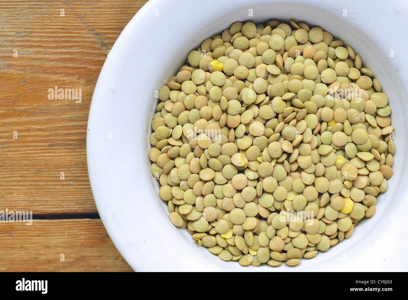 raw dry lentil beans in white bowl ; focus on lentil Stock Photo