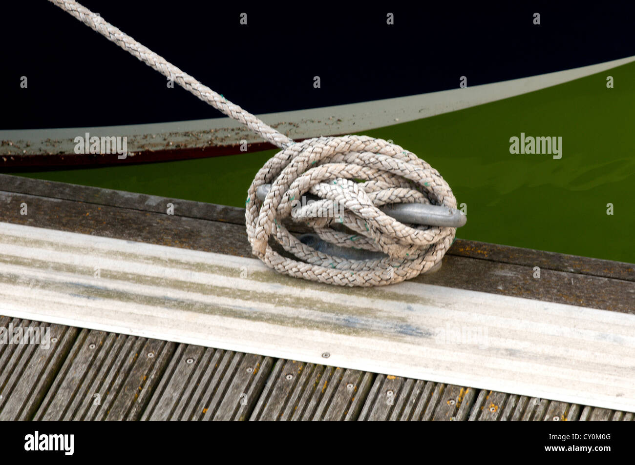 Rope Tying a Boat to the Dock Stock Photo