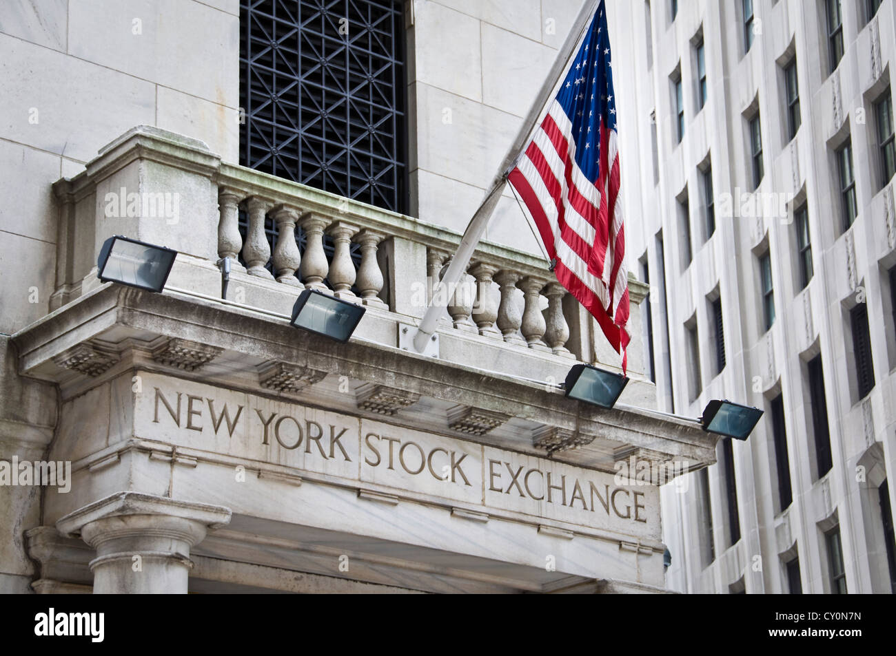 New York Stock exchange front facade with the american flag - New York City, USA Stock Photo