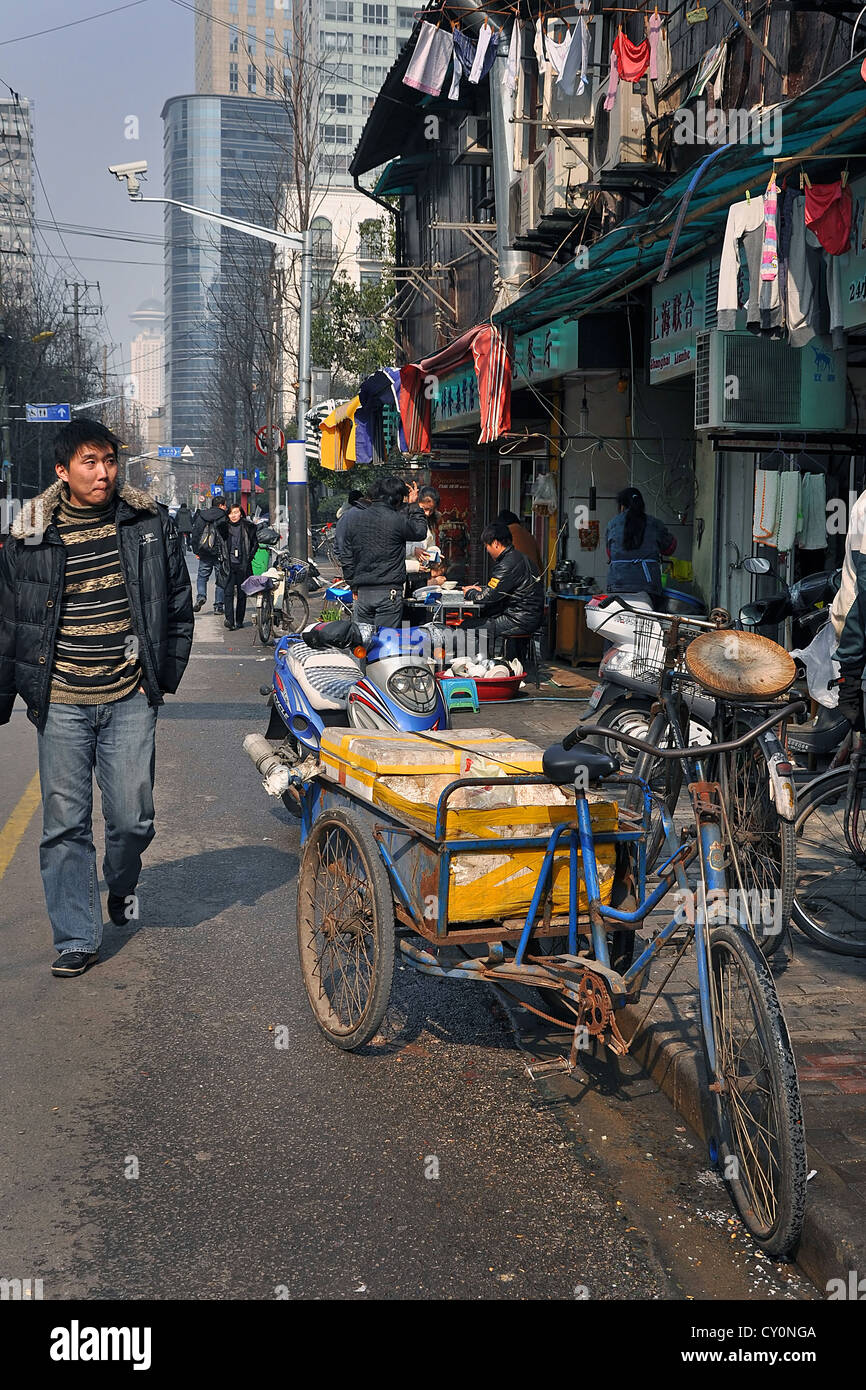 Chinese man walking in a street of Shanghai old town (Nanshi district)  - China Stock Photo