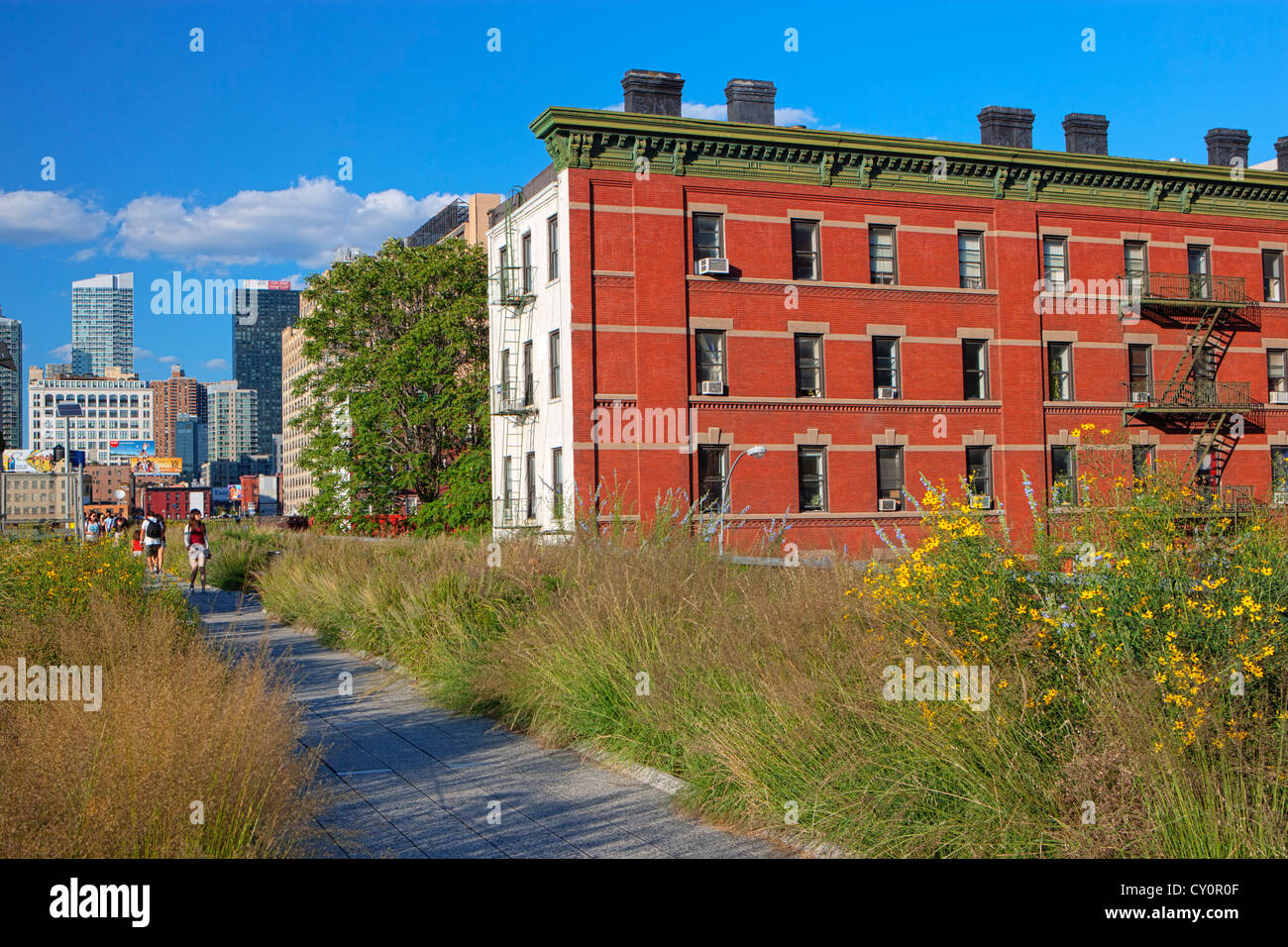 The High Line Elevated Park passes by residential red brick building Stock Photo