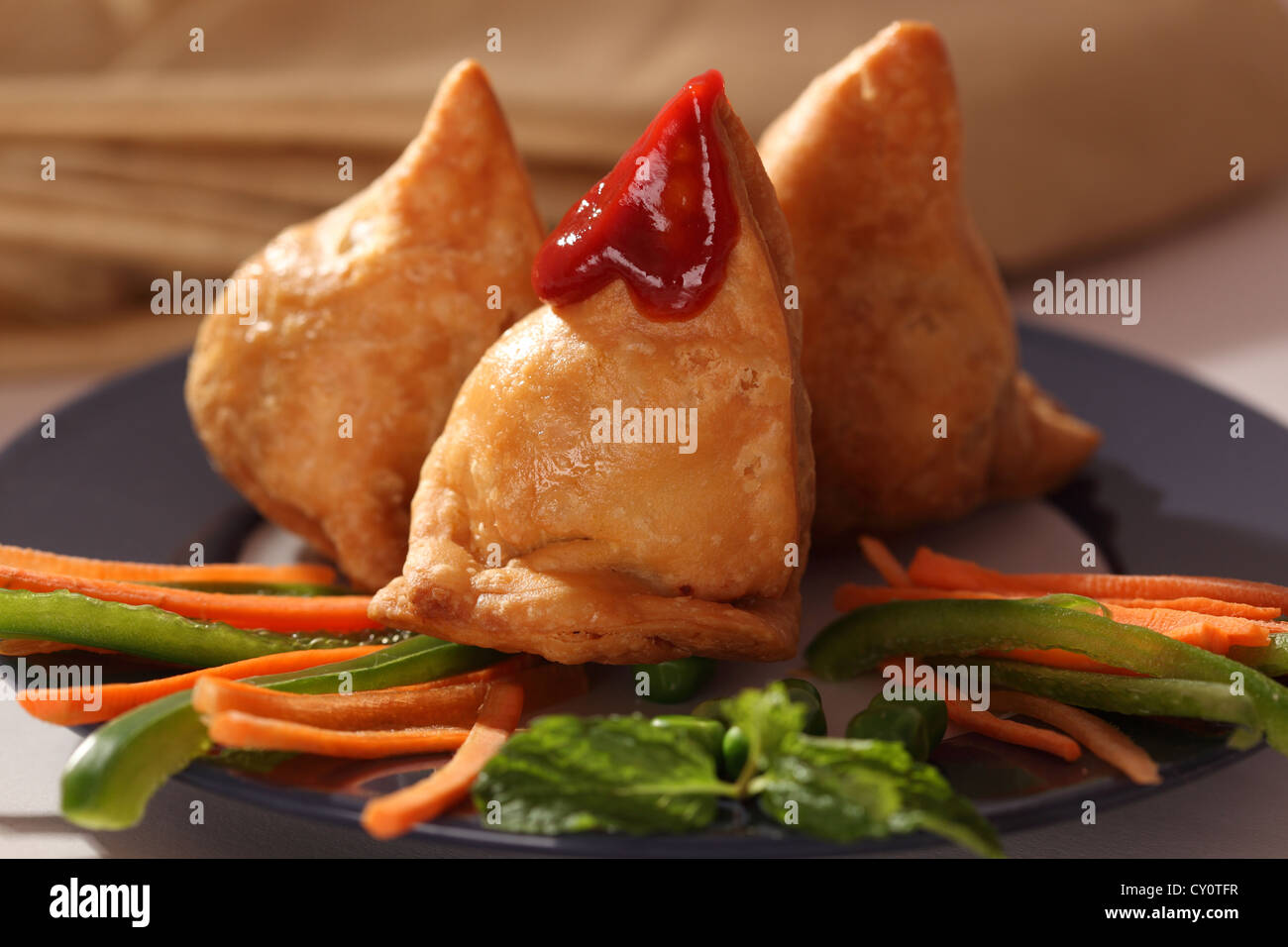 Samosa is an Inidan fried or baked pastry with a savory filling, such ...