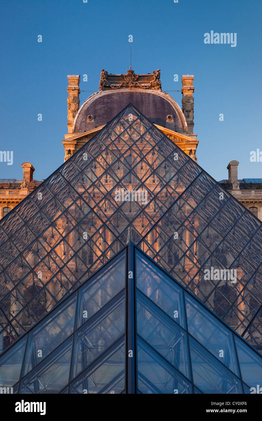Evening at the glass pyramid at Musee du Louvre, Paris France Stock Photo