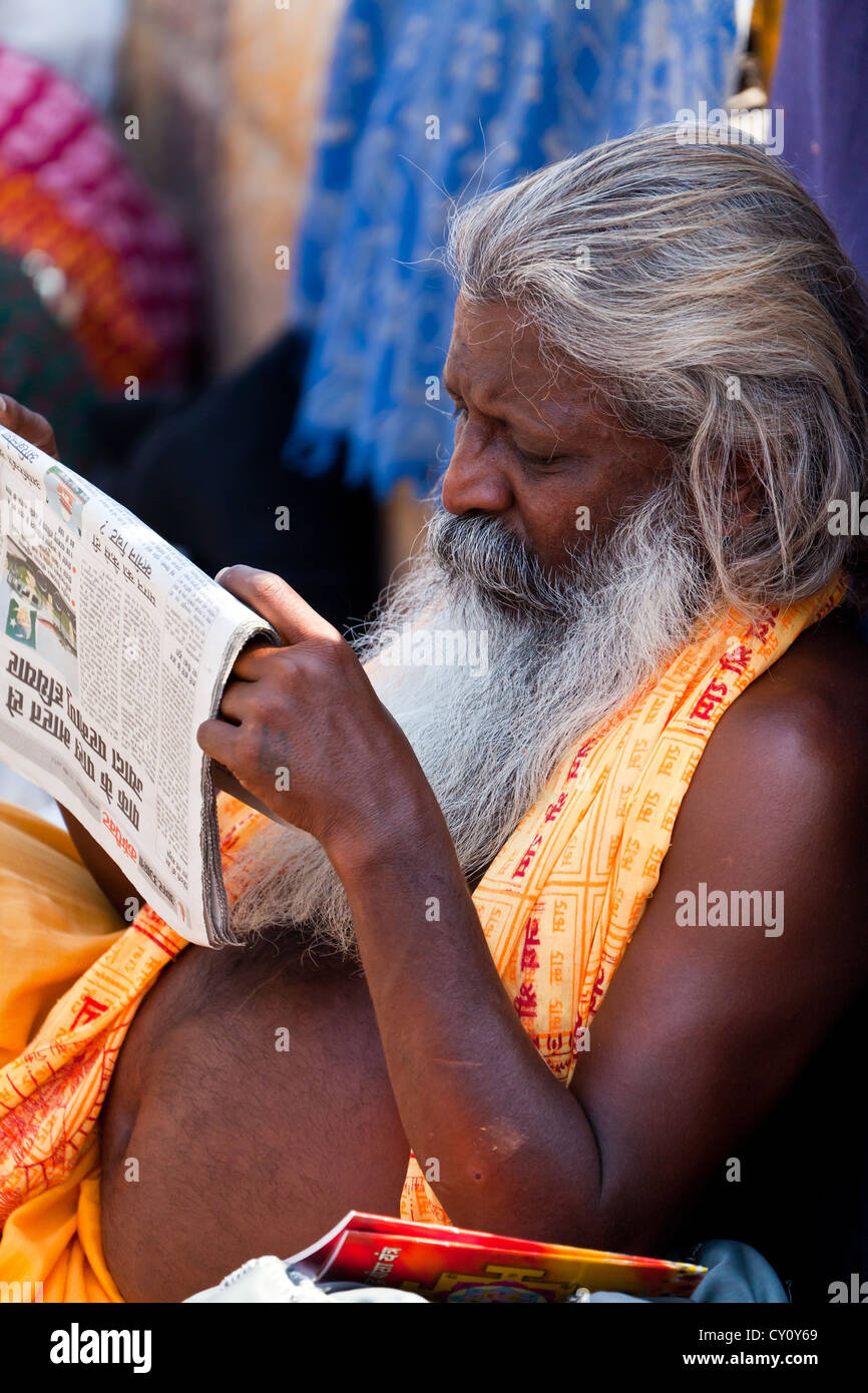 Man reading a Newspaper on the Street in Varanasi, India Stock Photo