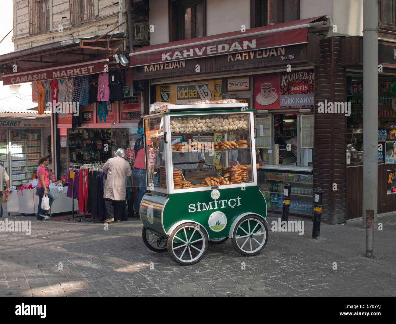 Ambulant vendor selling simit a Turkish bread ring from a cart  in the market district of Bursa Turkey Stock Photo