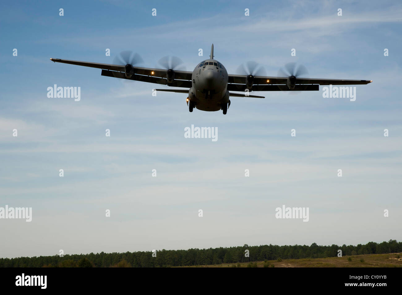 A U.S. Air Force C-130J Hercules aircraft comes in for a landing at Geronimo landing zone during a field exercise at the Joint Readiness Training Center (JRTC), Fort Polk, La., Oct. 15, 2012. JRTC 13-01 is designed to prepare and educate U.S. military Service members for deployments to the Middle East. Stock Photo