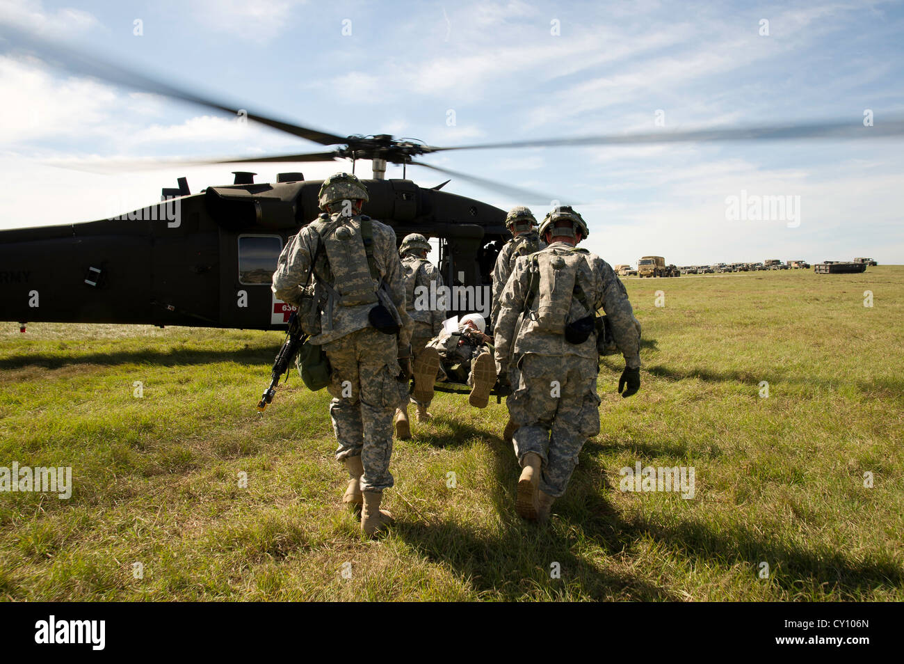 U.S. Army Soldiers load a simulated patient onto a UH-60M Black Hawk helicopter during a field exercise at the Joint Readiness Training Center (JRTC), Fort Polk, La., Oct. 15, 2012. JRTC 13-01 is designed to prepare and educate U.S. military Service members for deployments to the Middle East. Stock Photo