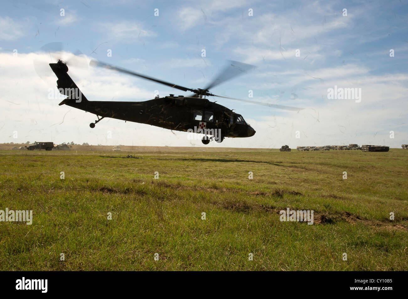 A U.S. Army UH-60M Black Hawk helicopter takes off from a landing zone after retrieving simulated patients during a field exercise at the Joint Readiness Training Center (JRTC), Fort Polk, La., Oct. 15, 2012. JRTC 13-01 is designed to prepare and educate U.S. military Service members for deployments to the Middle East. Stock Photo
