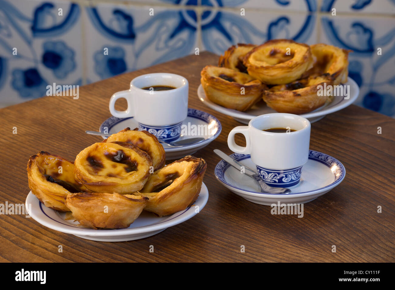 Pasteis de Nata or Pasteis de Belem; custard tarts, on a café table with bica coffees; Belém, Lisbon, Portugal Stock Photo