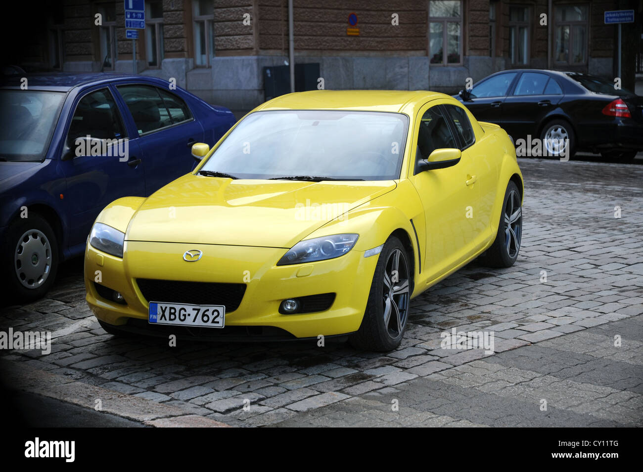 Editorial ** Helsinki, Finland - May 11, 2009 - Yellow Mazda RX-8 sports car powered by unique rotary ('Wankel') engine. Stock Photo