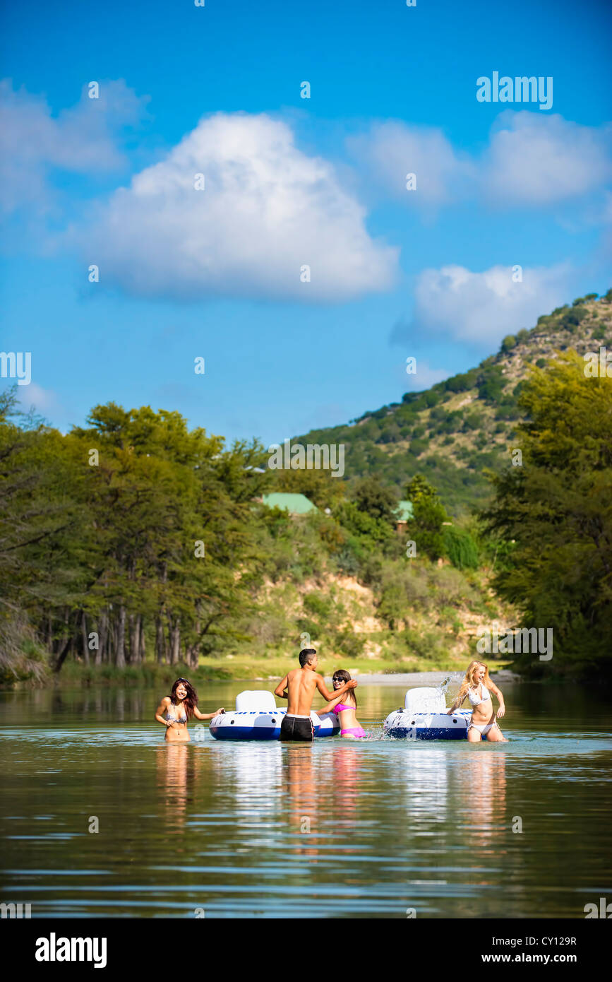 American teenagers tubing the Frio River near Concan, Texas, USA Stock