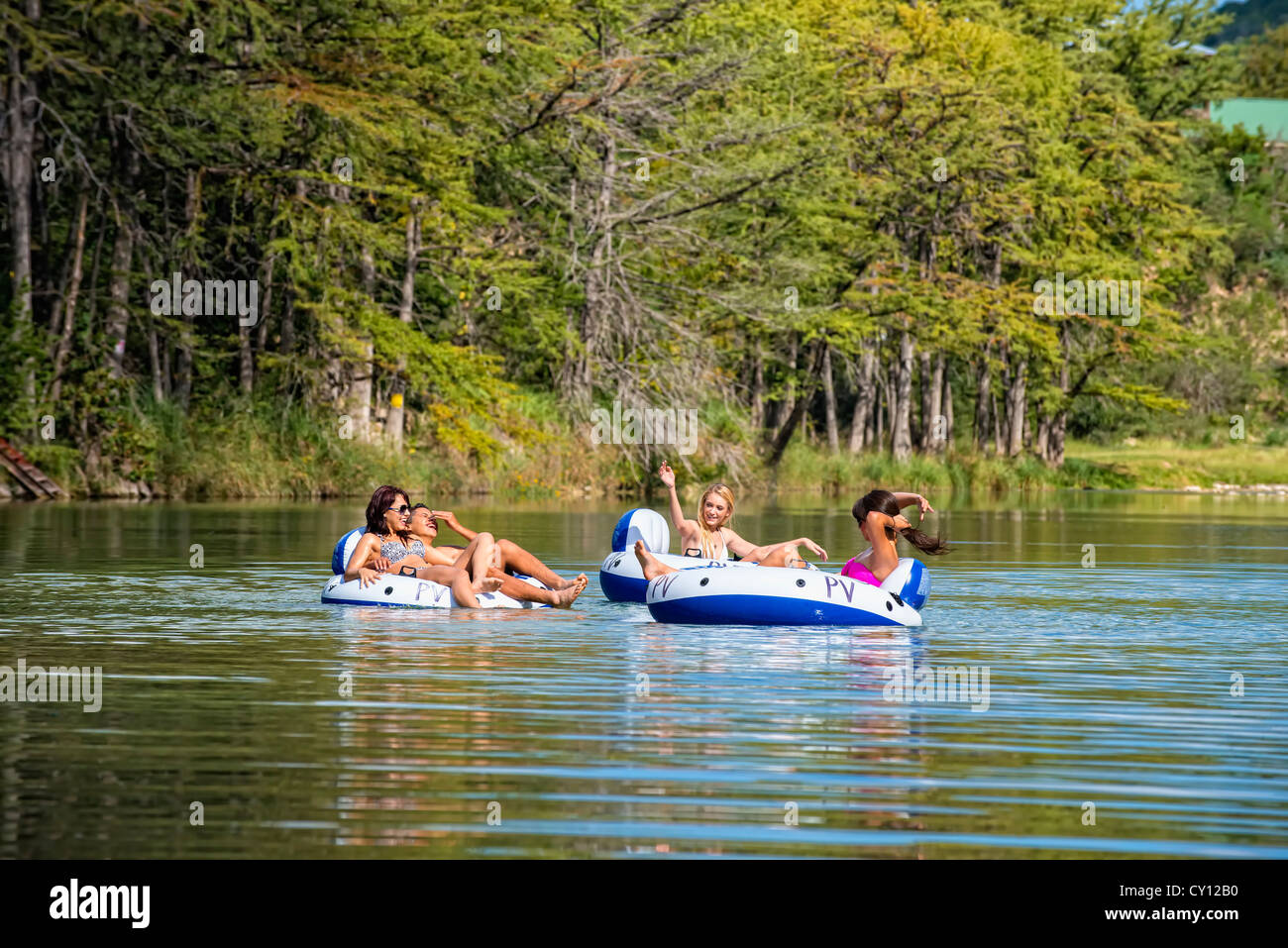 Young people floating down the Frio River an inflatable tubes Stock Photo