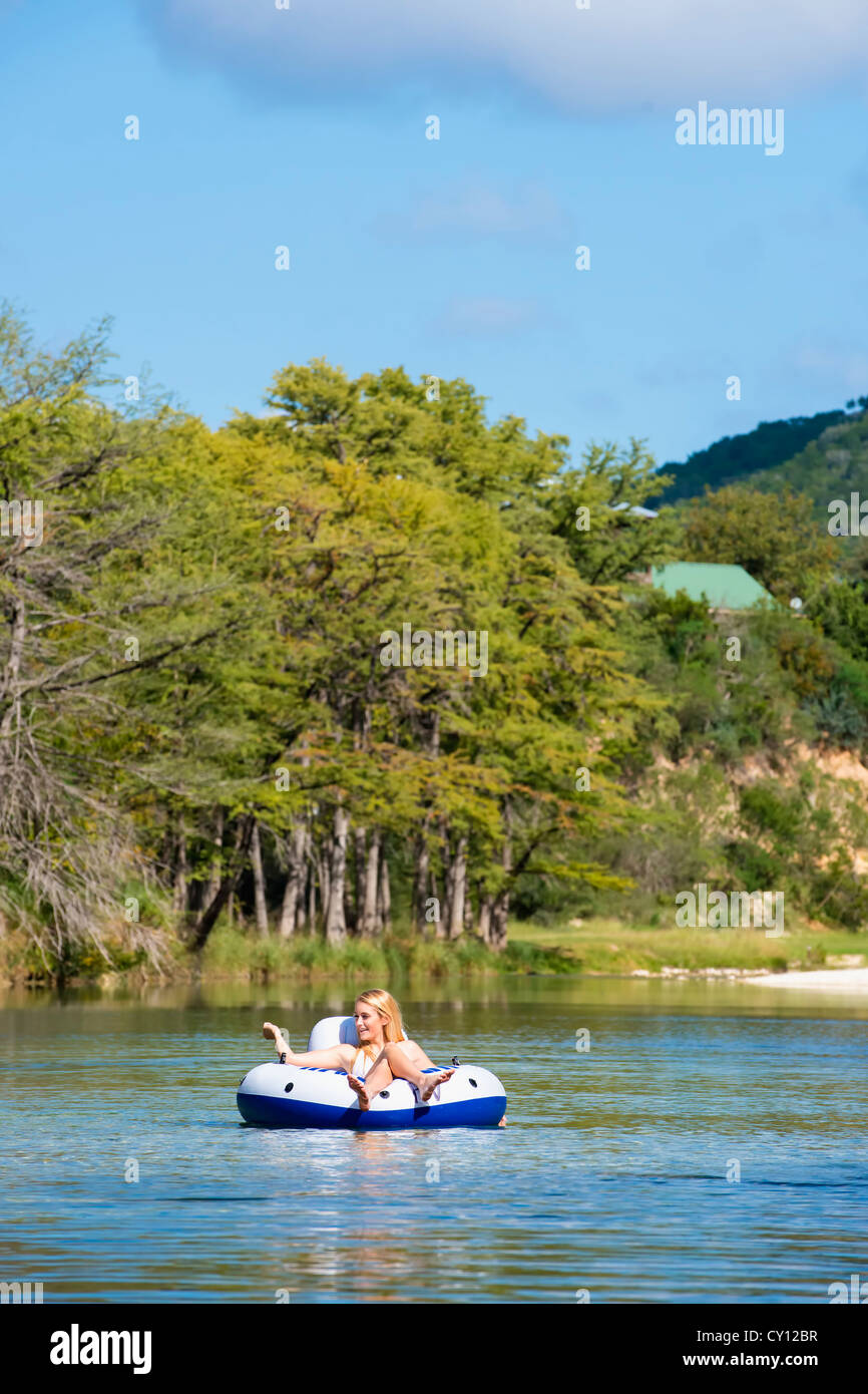 Teenage girl of 16 years floating down the Frio River in Texas, USA