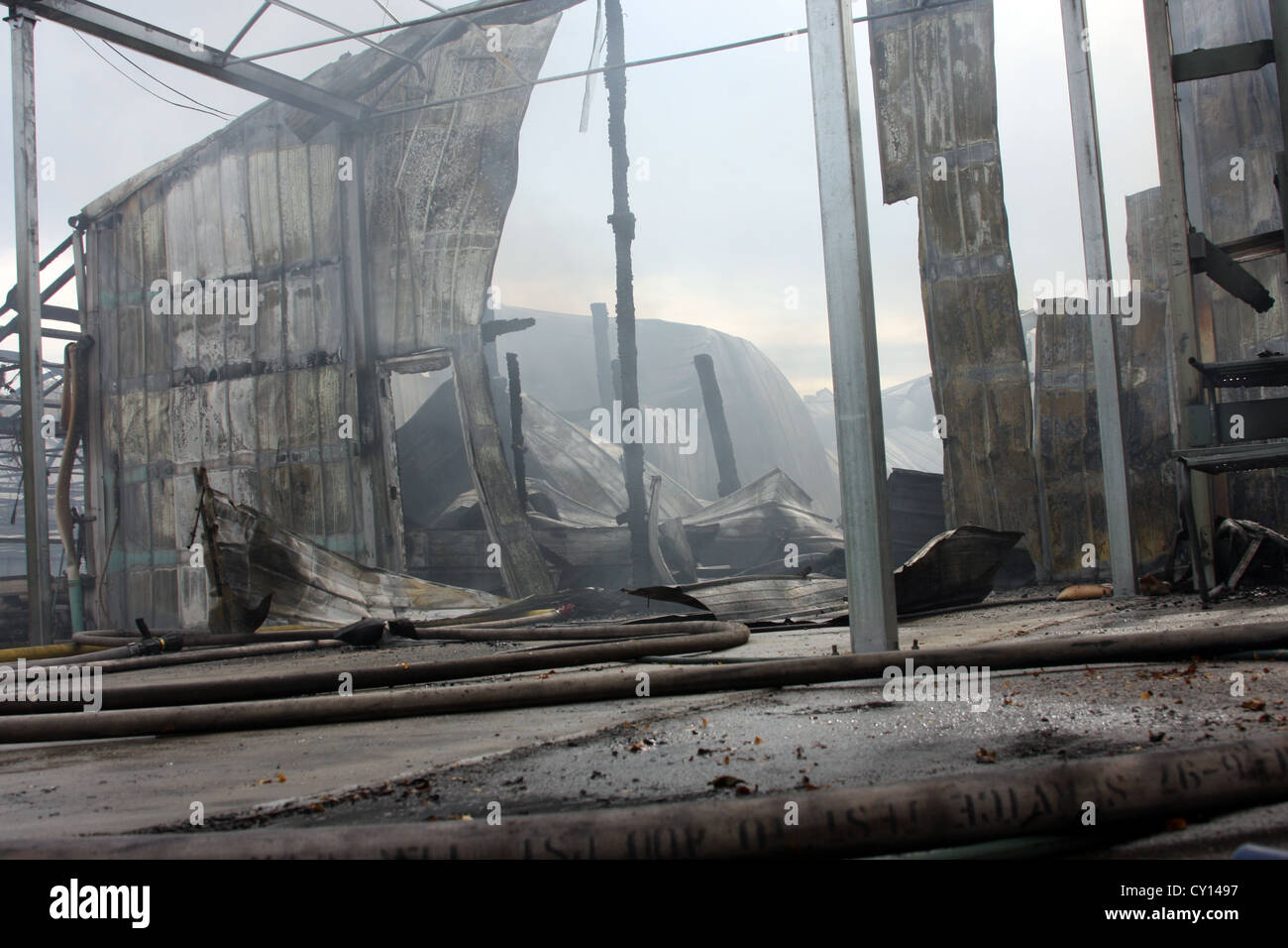 The aftermath scene of an industrial fire with a roof collapse in Menomonee Falls WI Stock Photo